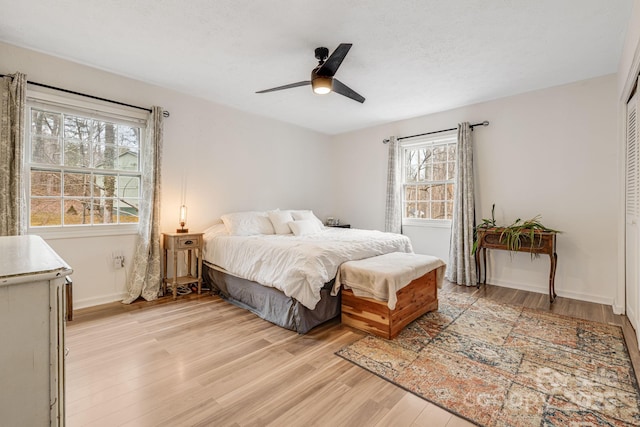 bedroom with a closet, ceiling fan, and light hardwood / wood-style flooring