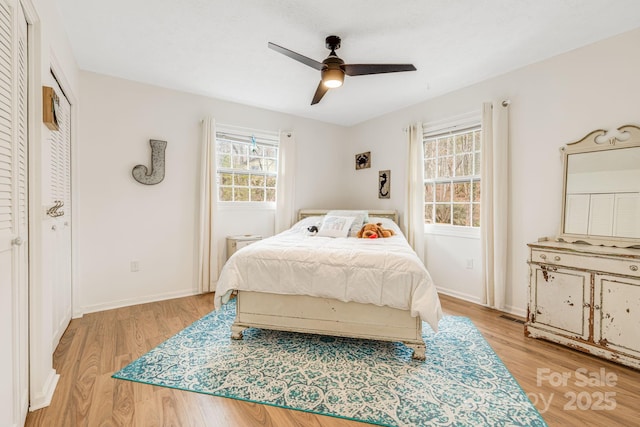 bedroom with light hardwood / wood-style flooring, a closet, and ceiling fan