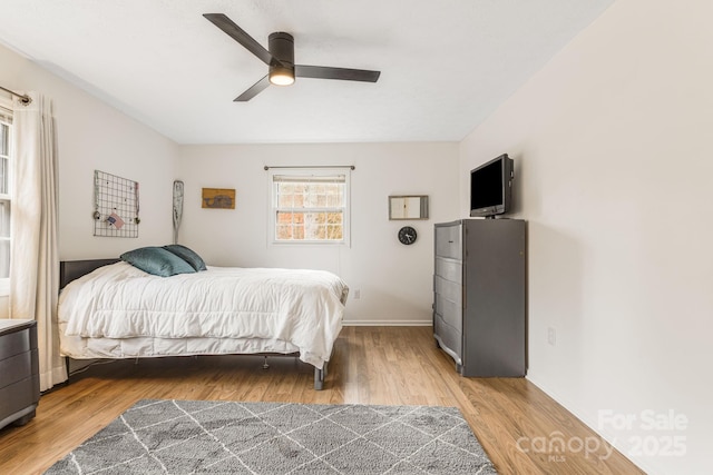 bedroom with wood-type flooring and ceiling fan