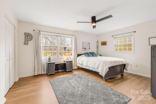 bedroom with ceiling fan, hardwood / wood-style floors, and a closet