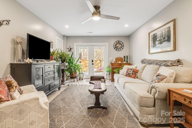 living room with french doors, ceiling fan, and wood-type flooring