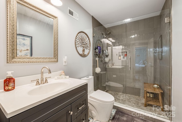 bathroom with walk in shower, vanity, and toilet