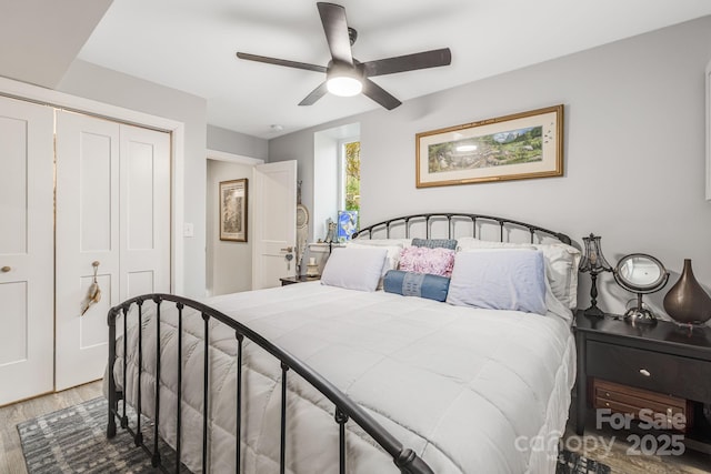 bedroom with wood-type flooring, a closet, and ceiling fan