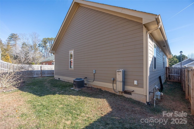 view of property exterior featuring central AC and a yard