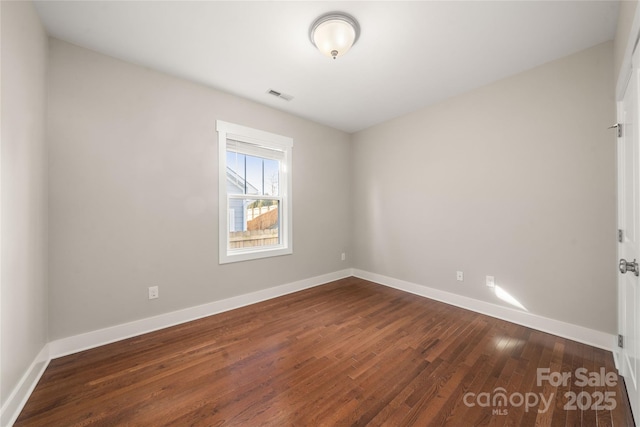 empty room featuring dark wood-type flooring