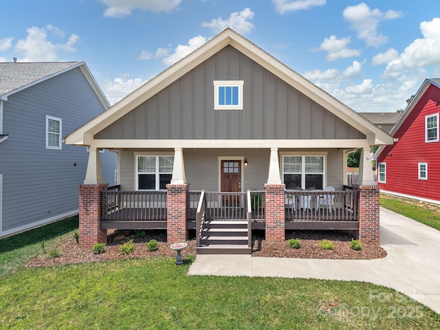 9 Hyde Park Pl, Arden, NC 28704 - craftsman-style house with board and batten siding, a porch, and a front lawn