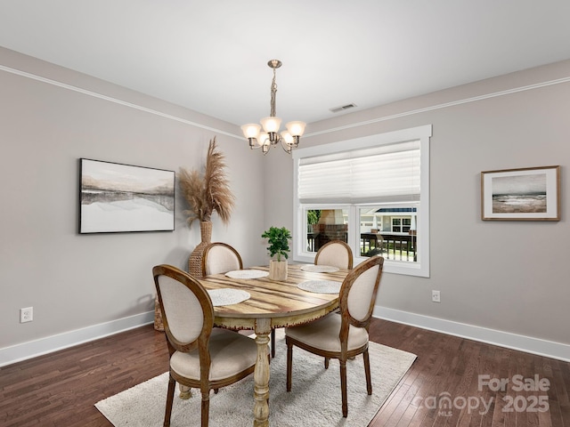 9 Hyde Park Pl, Arden, NC 28704 - dining area featuring a chandelier, wood finished floors, and baseboards