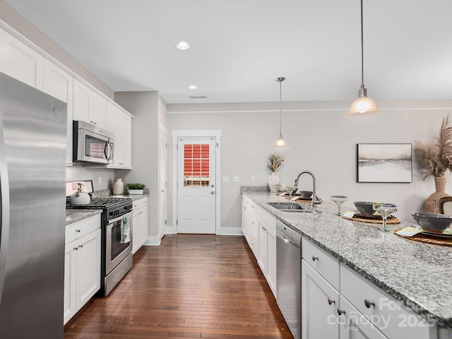 9 Hyde Park Pl, Arden, NC 28704 - kitchen featuring stainless steel appliances, a sink, dark wood finished floors, white cabinetry, and light stone countertops