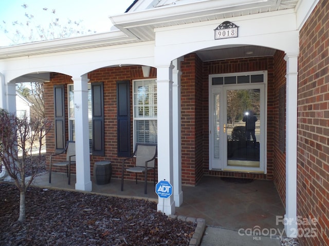 view of exterior entry featuring a porch