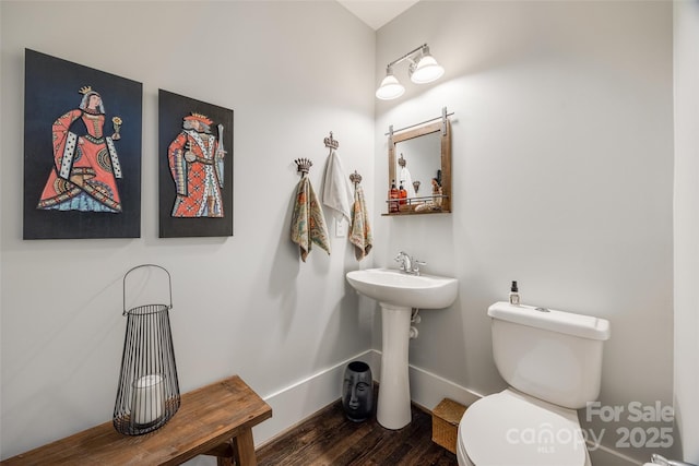 bathroom featuring hardwood / wood-style floors and toilet