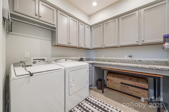 washroom featuring cabinets and independent washer and dryer