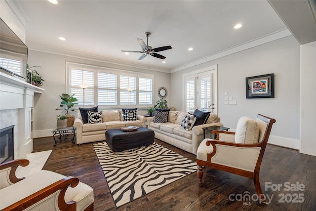 living room with crown molding, dark hardwood / wood-style floors, ceiling fan, and a high end fireplace