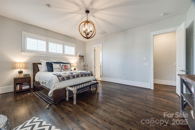 bedroom with dark wood-type flooring and an inviting chandelier