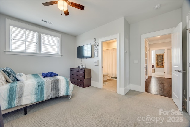 carpeted bedroom featuring ensuite bathroom and ceiling fan