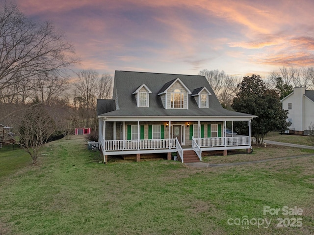 view of front of home featuring a porch and a yard