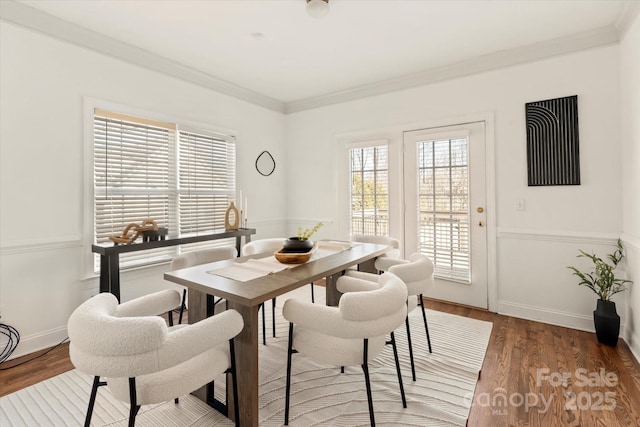 dining space featuring hardwood / wood-style flooring and ornamental molding