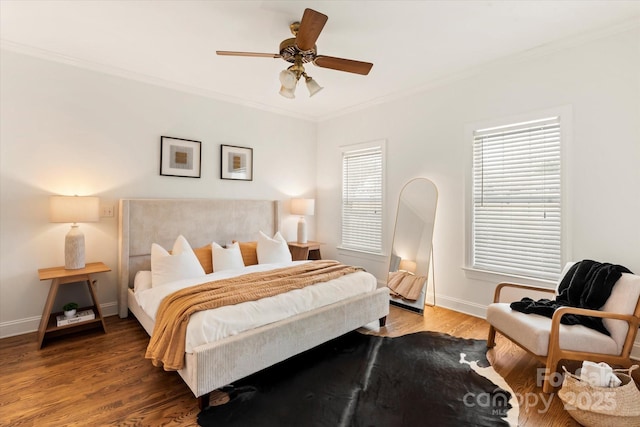 bedroom with hardwood / wood-style floors, crown molding, and ceiling fan