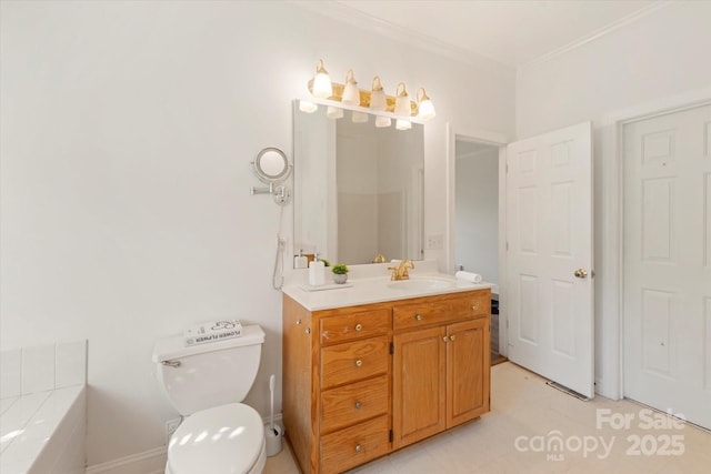 bathroom with vanity, a bathtub, ornamental molding, and toilet