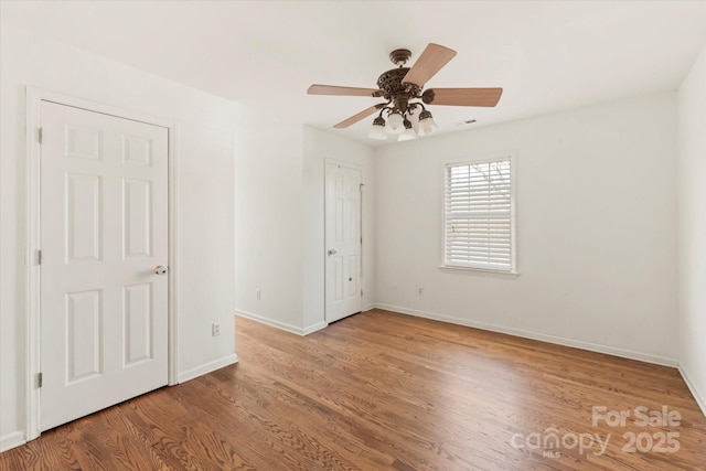 spare room with ceiling fan and light wood-type flooring