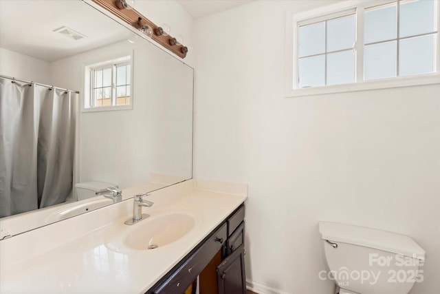 bathroom featuring vanity and toilet