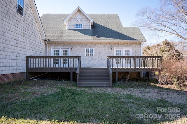 rear view of property with a wooden deck and a yard