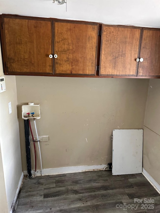 laundry room featuring cabinets, washer hookup, and dark hardwood / wood-style flooring