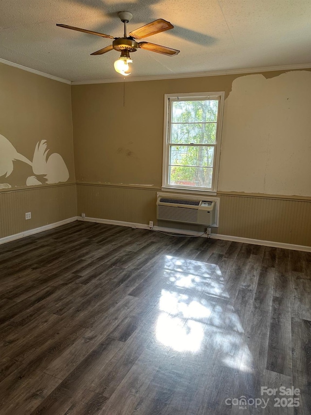 spare room featuring crown molding, a textured ceiling, dark hardwood / wood-style floors, a wall unit AC, and ceiling fan