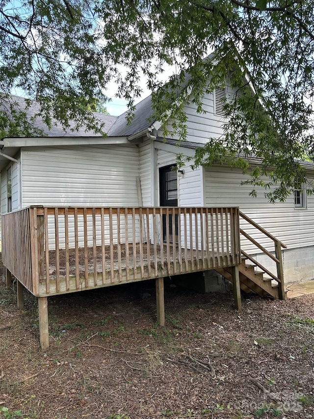 rear view of property featuring a deck