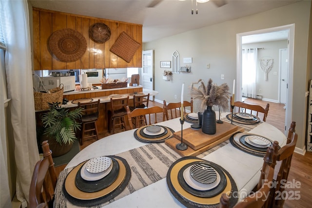 dining space with ceiling fan and hardwood / wood-style floors