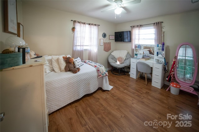 bedroom with ceiling fan and dark hardwood / wood-style flooring