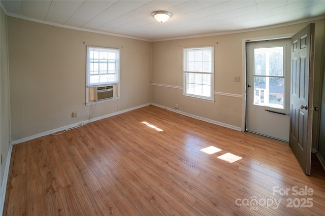 spare room featuring light hardwood / wood-style flooring and ornamental molding