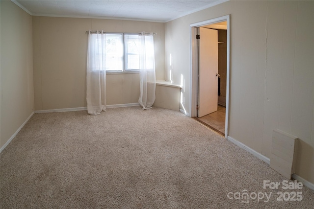 spare room featuring light carpet and ornamental molding