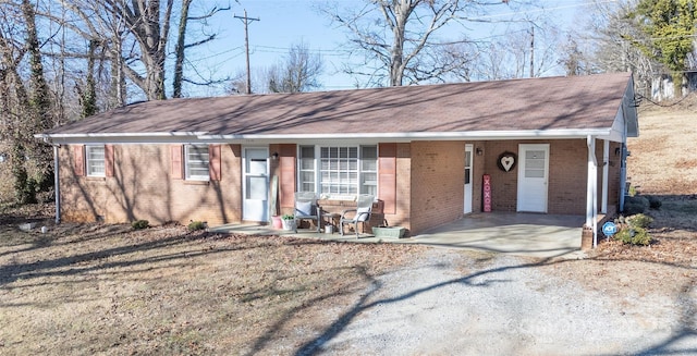 ranch-style home featuring a carport