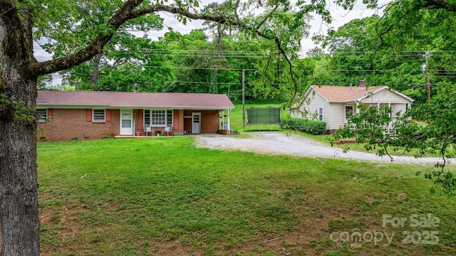 ranch-style home with a front lawn and covered porch