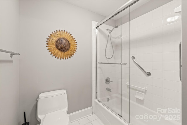 bathroom featuring bath / shower combo with glass door, tile patterned floors, and toilet