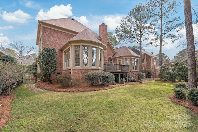 back of house with a wooden deck and a yard