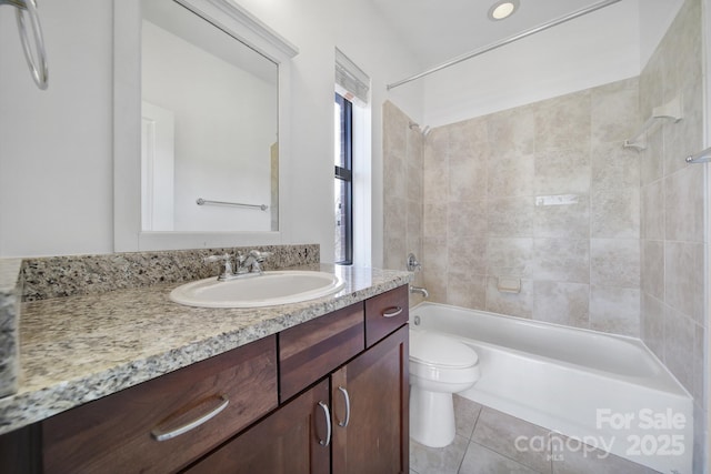 bathroom with toilet, tile patterned flooring, vanity, and shower / bathtub combination