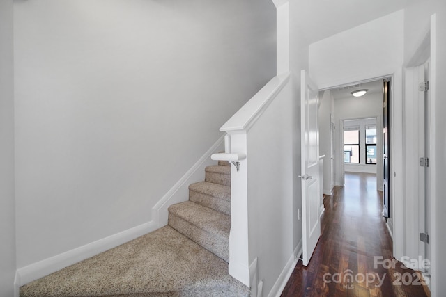 stairs featuring baseboards and wood finished floors