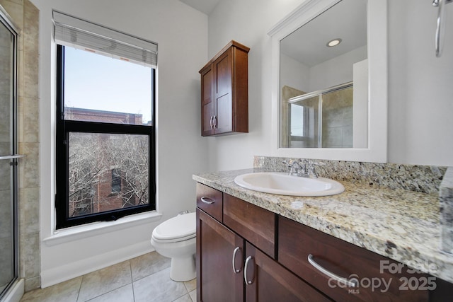 bathroom with a stall shower, tile patterned flooring, vanity, and toilet