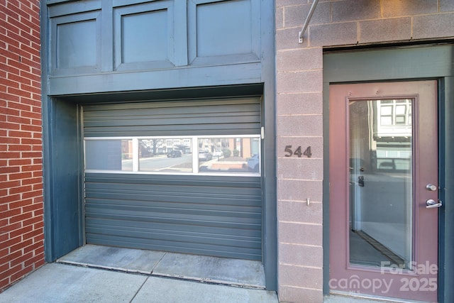 view of exterior entry with brick siding