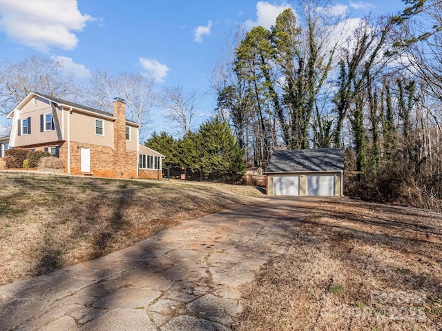 view of home's exterior featuring a garage and an outdoor structure