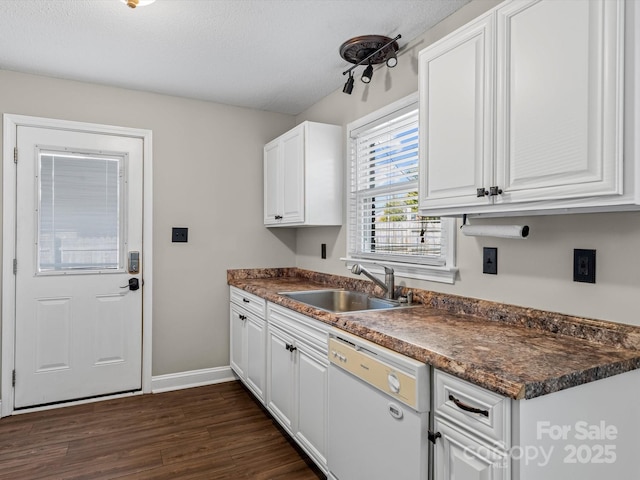 kitchen with sink, dark wood-type flooring, dishwasher, white cabinetry, and a textured ceiling