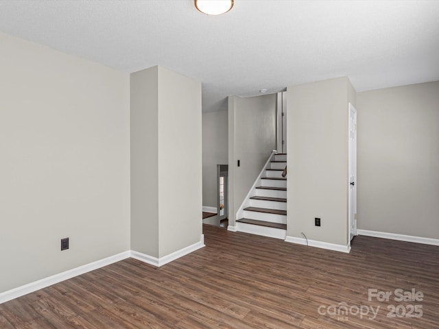 basement with dark hardwood / wood-style floors