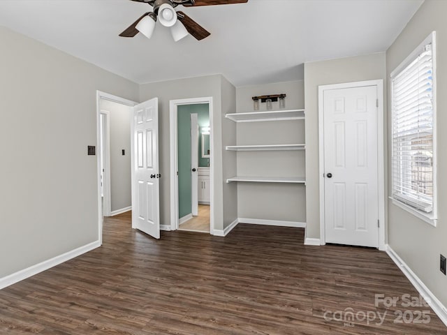 unfurnished bedroom featuring dark hardwood / wood-style floors, ceiling fan, and a closet