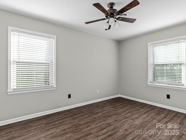 spare room featuring dark hardwood / wood-style floors and ceiling fan