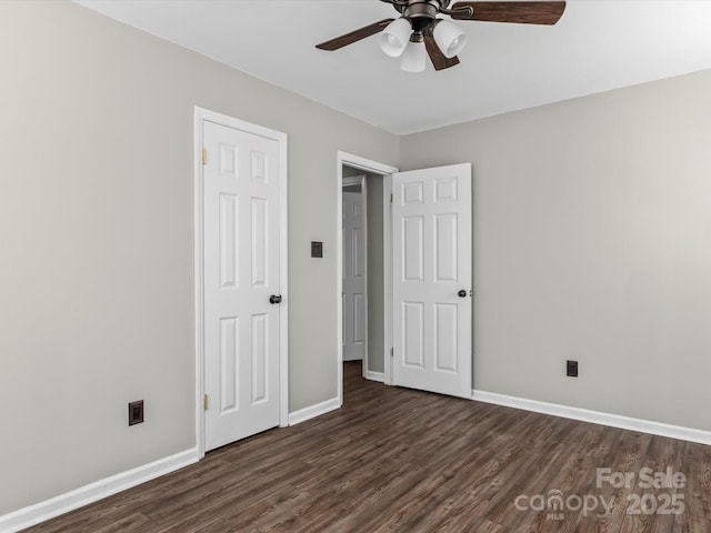 unfurnished bedroom featuring dark hardwood / wood-style floors and ceiling fan