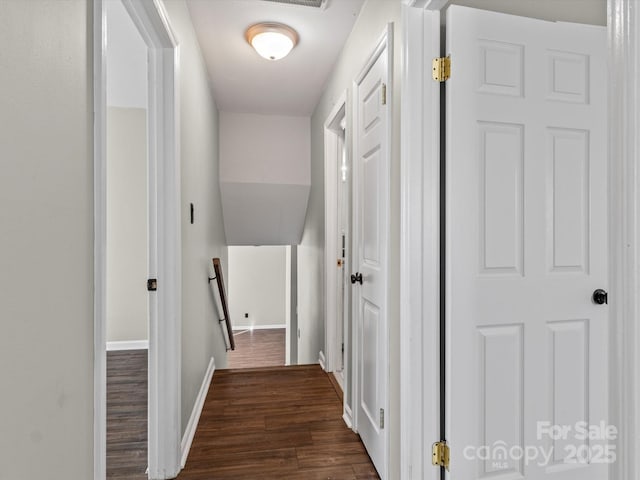 hall with dark wood-type flooring