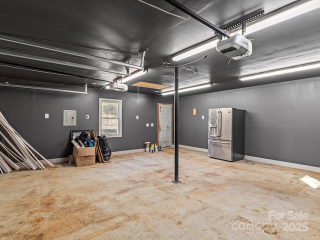 garage with a garage door opener and stainless steel fridge