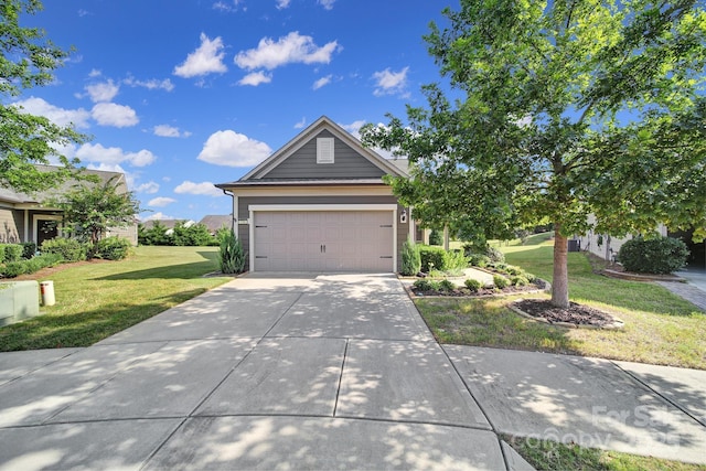 view of front of home with a garage and a front lawn