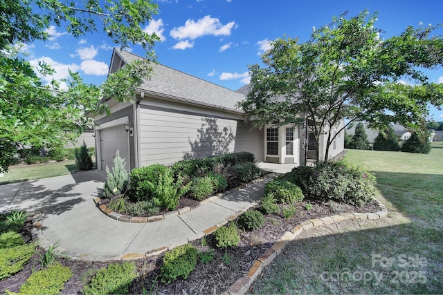 view of front of property with a garage and a front yard